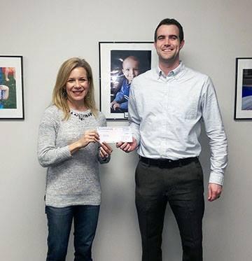 Presenting a donation check to one of our great partners, Heroes For Children.