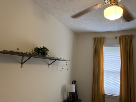 reclaimed wood shelf, wall mounted. 
 curtain rod & curtains hung.