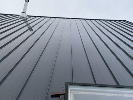 A close-up photo of a post metal roof cleaning