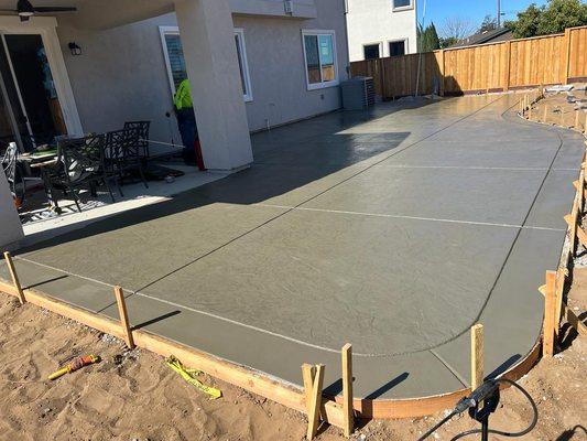 Stamped concrete always makes the yard look better .