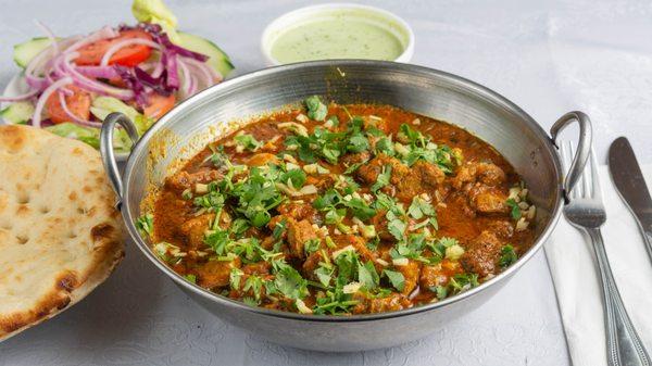 Chicken Karahi is served with two Tandoori Naan, salad and chutney