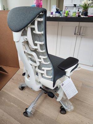 Herman Miller Embody Chair with White Frame, Titanium base, Dark Carbon upholstery and translucent casters.