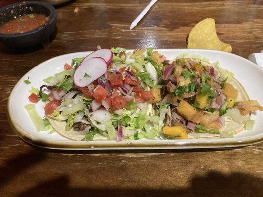 Carne asada and carnitas tacos.