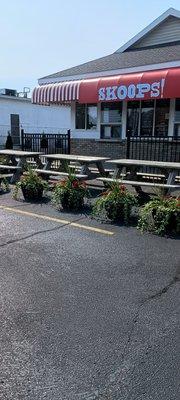 Picnic tables in front of building .