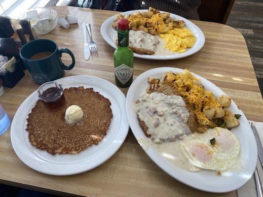 Chicken fried steak, eggs over medium with country potatoes & a pancake. It's delicious with green Tabasco.