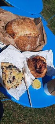 Still warm sourdough round, blueberry scone with side of lemon curd, marionberry pastry. Yum!!