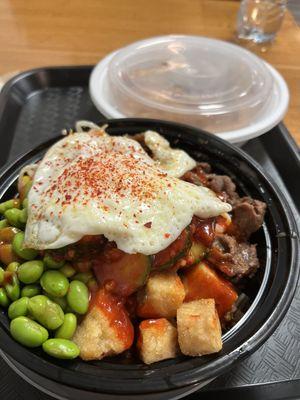 Traditional warm bibimbap w egg and some mandu on the side. Yum!