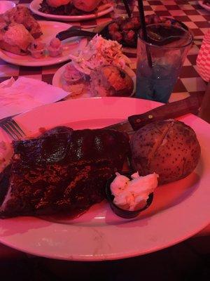 It's chicken and ribs with a baked potato on the side! (The chicken is under the ribs)