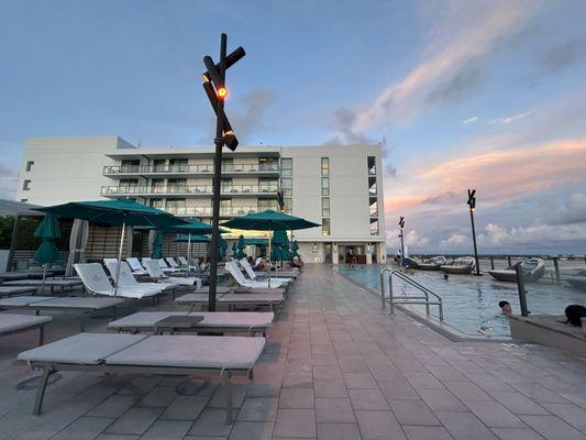 The infinity pool with comfy lounge chairs and a little sneak peek at the cooking hot jacuzzi next to it!