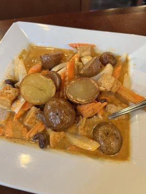 Scrumptious chunky potatoes in massaman curry (peanut/cashew) sauce with onions and carrots. Delicious!