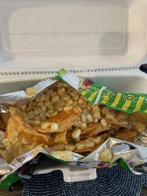 Salsa verde Tostitos with nacho cheese and corn.