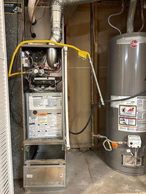 This is a code violation photo, showing a gas flex line going into the furnace cabinet.