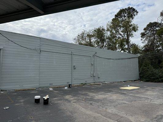 Before and after of some siding repair and full exterior paint on building