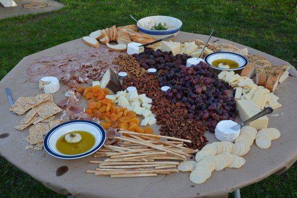 Farmers Table: nuts, fruit, breads, cheeses, and cured meat display.