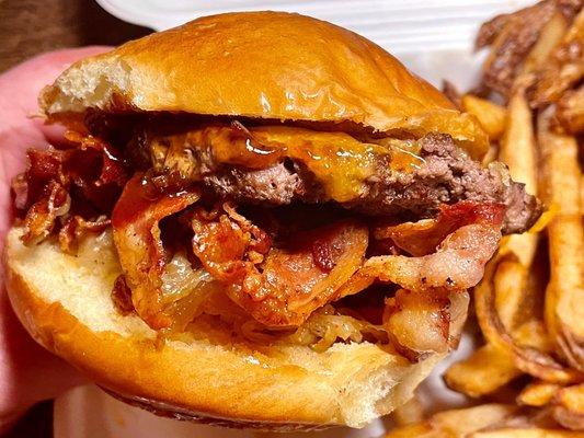 Cheddar Bacon Burger - 1/4lb beef patty, cheddar, applewood smoked bacon, grilled onions, bbq sauce on a potato bun + fries