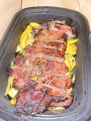 Normal Hanger steak over a bed of squash and zucchini