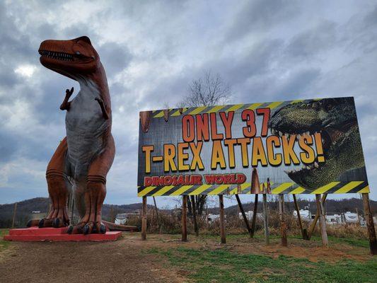 Giant dino and billboard near highway