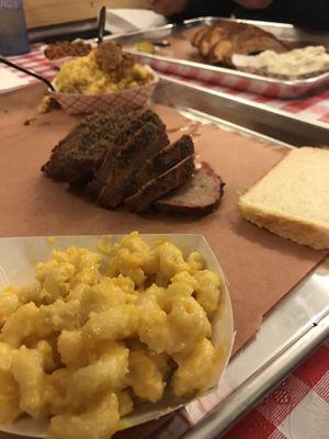 Sliced tri tip with a side of Mac n cheese and cornbread casserole.