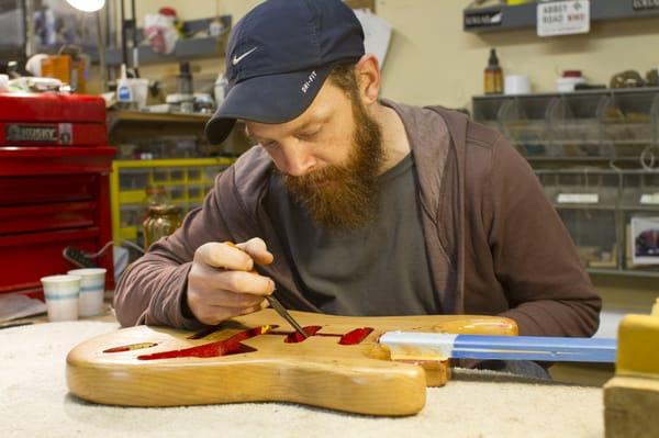 Technician Joe Swierupski prepares to refinish a vintage Strat