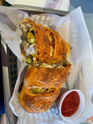 Stromboli with dipping sauce.