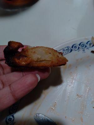 Top portion of burnt, soggy potato wedge.