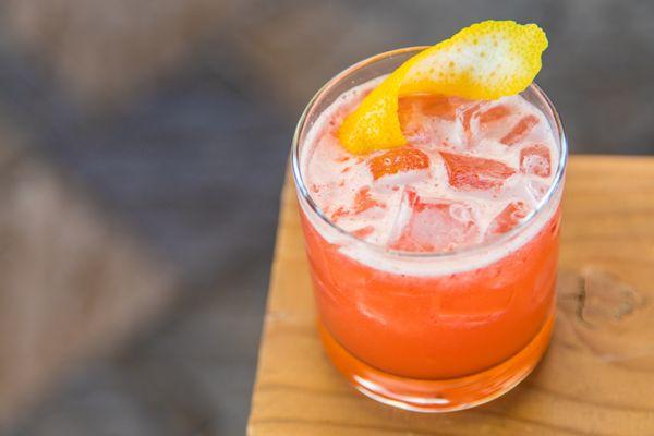 Sunday Elixir with whiskey, fresh muddled raspberries & citrus.