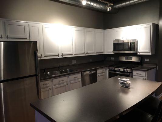 Newly re finished and painted white cabinets from original wood stain.