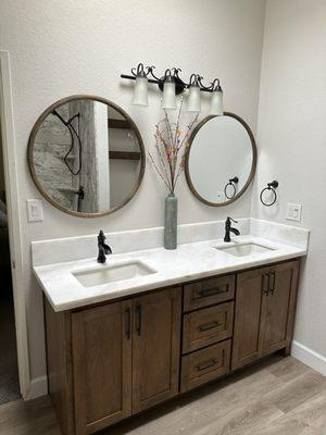 New vanity, quartz counter, sinks, and faucets.