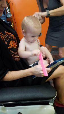 She even let him watch videos.. he also enjoyed playing with a comb. He refused the cape though.