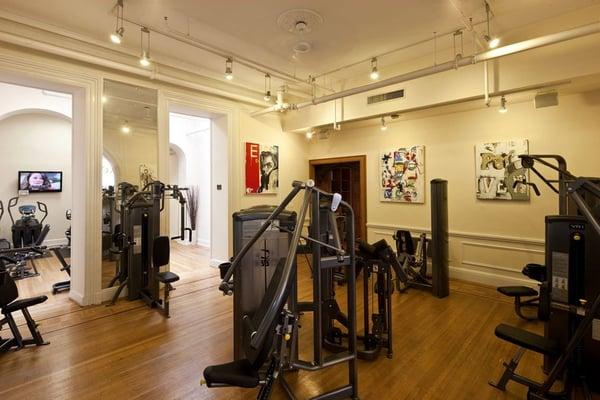 A complete circuit wurrounded by original fine art, arches, and hardwood floors.