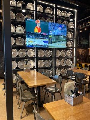 TV's and keg display on the inside of the restaurant.