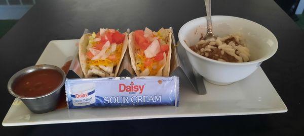 Steak tacos with side of refried beans.