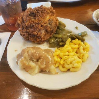 Mashed potatoes with gravy, green beans, mac-n-cheese & their over breaded fried chicken.