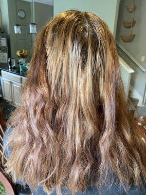 Uneven color with spots of blonde.