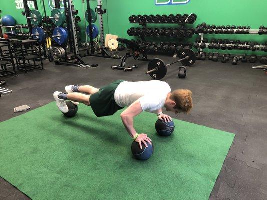 Kyle K. challenging core strength and shoulder/wrist stability in this advanced push-up.