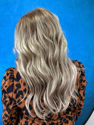 Hair extensions are hand sewn and blended into her highlighted haircolor