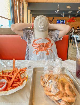 Shrimp, potatoes, corn and a side of sweet potato fries