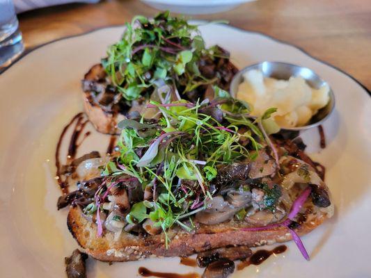 Mushroom Toast appetizer with arugula and balsamic vinegar.  Sooo tasty.