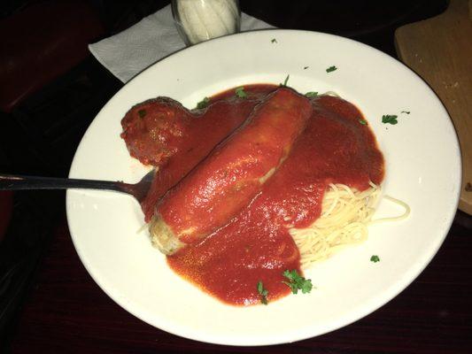 Meatball and sausage with delicious sauce over angel hair pasta that is served hot yet al dente . . .