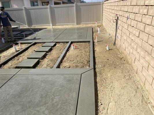 Poured in place concrete pads, stepping stones and curbing for this brand new design and construction by Ruff & Ready.