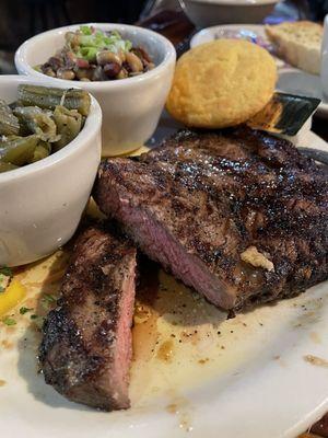 Big juicy ribeye with green beans and Black Eyed Peas and cornbread