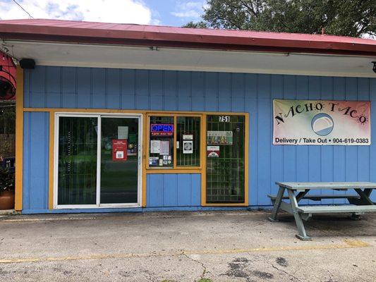 Front of the taco shop, you walk in through the sliders to order