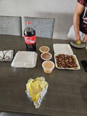 Caritas, Carne asada rice, beans, salsa, soda and tortillas.