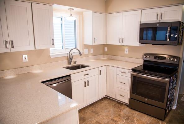 This is the Roma door in white chocolate Italian laminate, with a light neutral granite countertop. Storage optimizers maximize function.