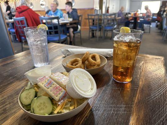 Salad, hush puppies, water and sweet tea.