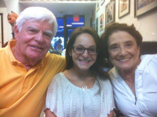 My daughter with her grandparents wearing her new glasses