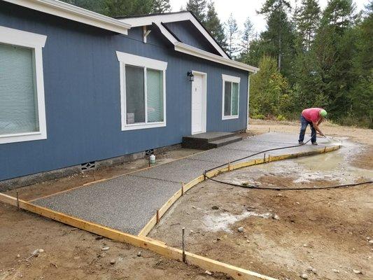 Front patio, rinsing off the top layer exposing the aggregate beneath.