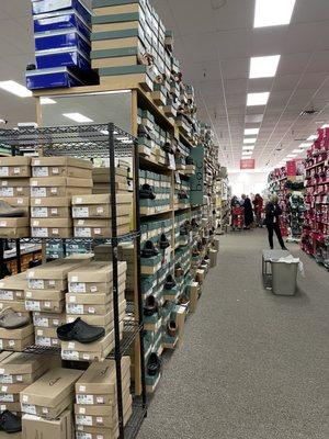 Brown cardboard shoeboxes on rack blocking off mirror