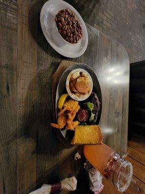 The meal it is the steak and shrimp combo with mashed potatoes and beefy baked beans