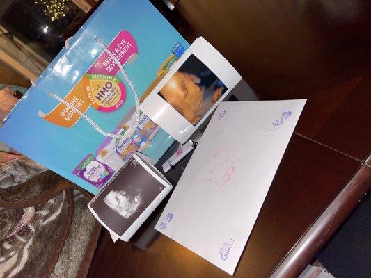 Baby pictures, USB stick, formula, and cute envelope.